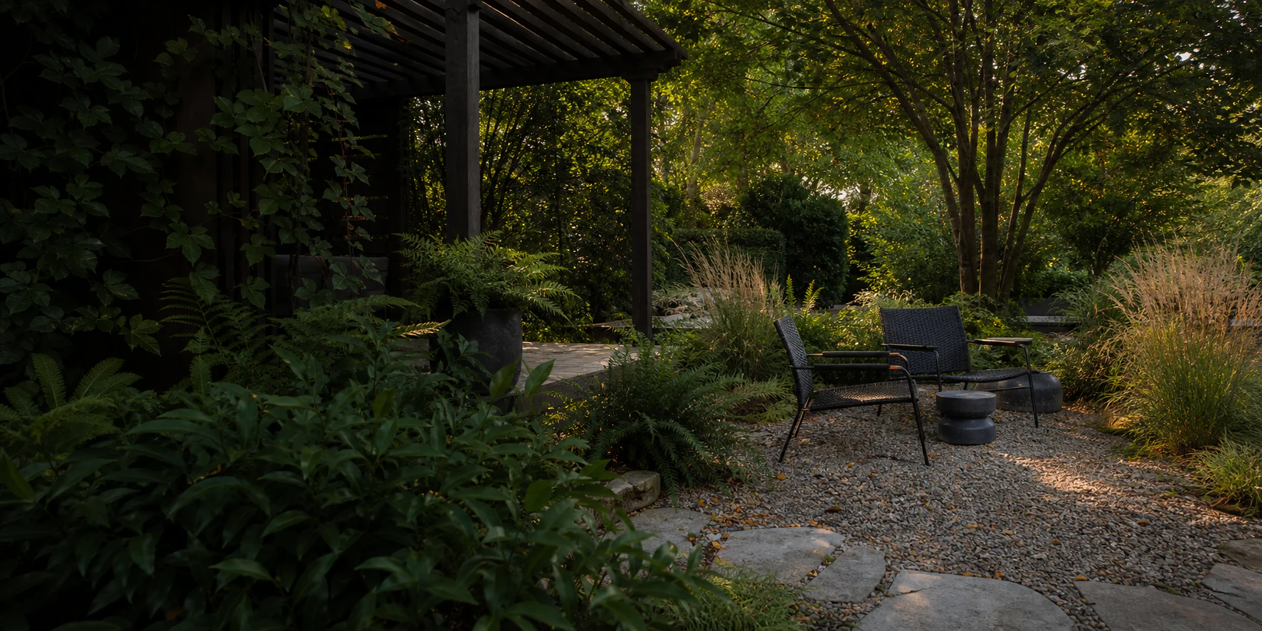 Mature residential garden with a timber pergola and gravel seating terrace